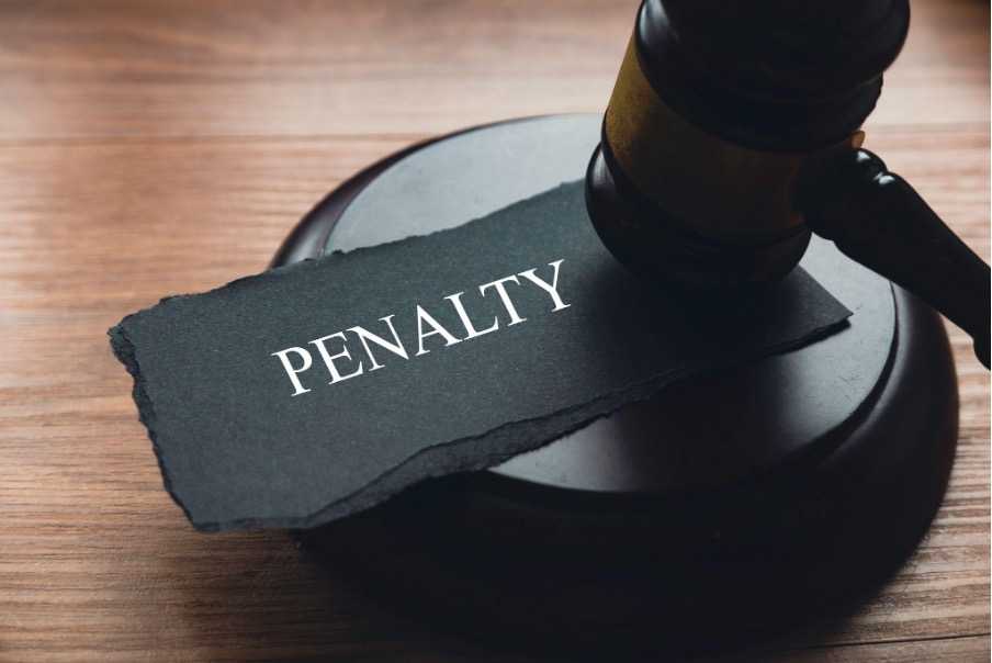A judge’s gavel sitting on top of the word “Penalty,” representing the penalty for refusing service dog in Florida.